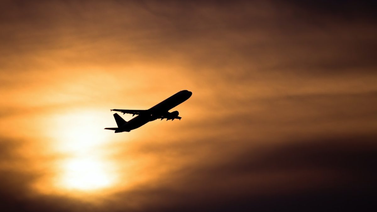 airplane silhouette takeoff sunset sky